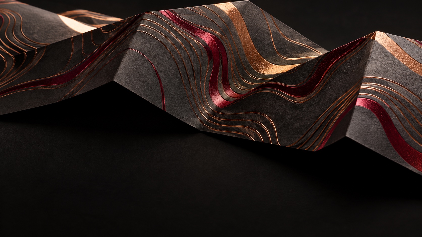 Concept artwork of copper and red foil contours on textured charcoal paper